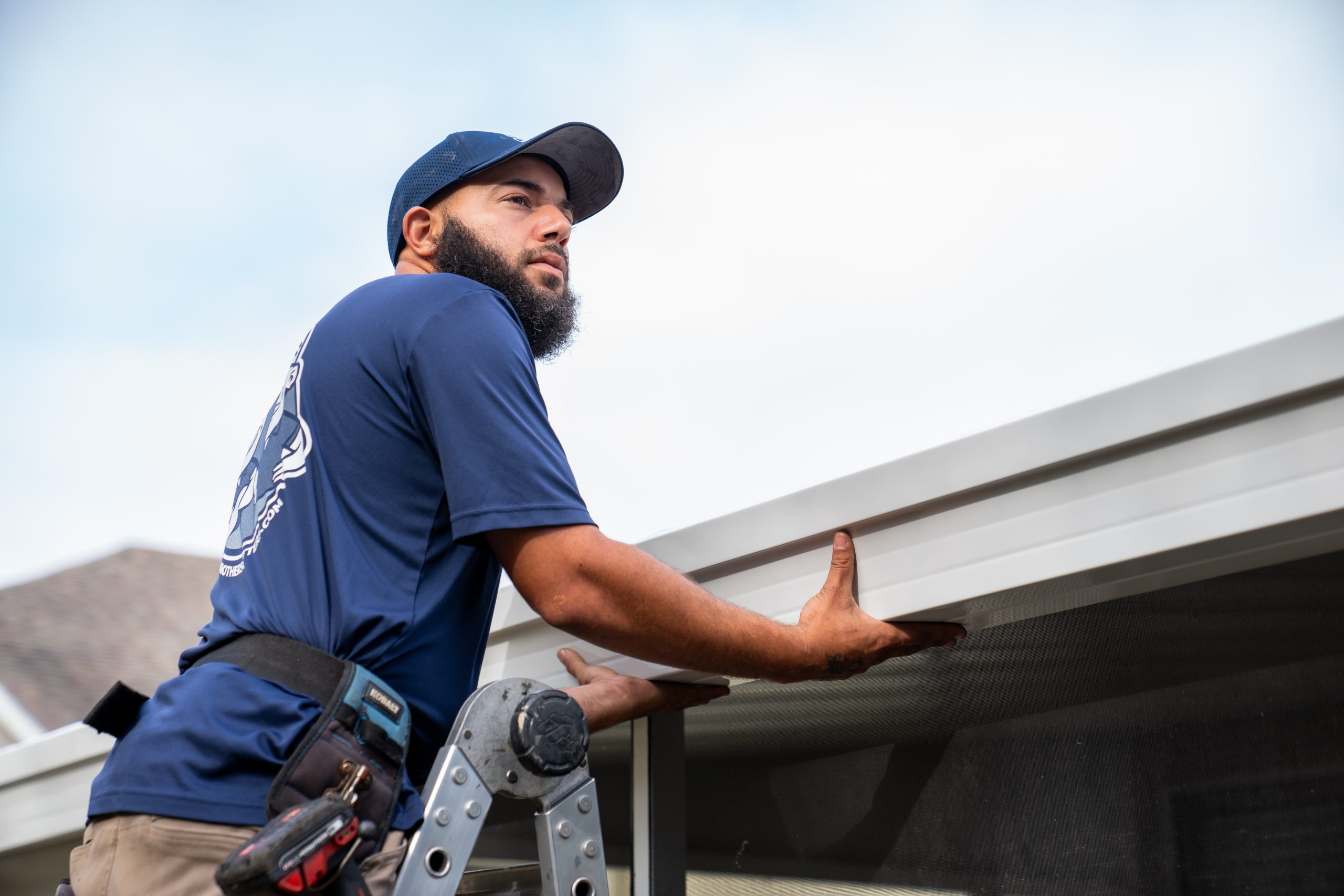 A Brothers That Just Do Gutters installer fitting BroGuard gutter guard on a Los Angeles home