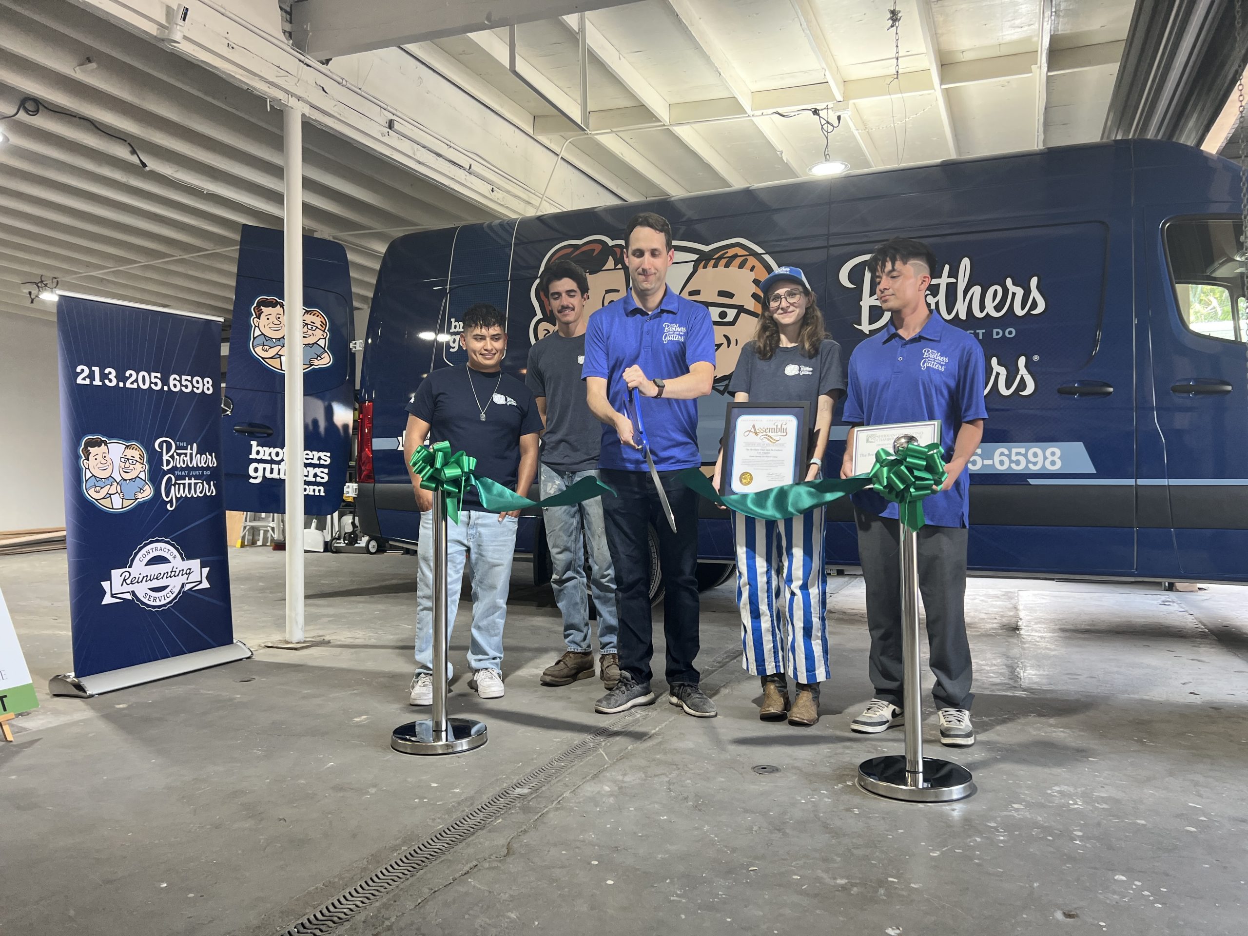 The Brothers That Just Do Gutters Los Angeles team at their grand-opening ribbon-cutting