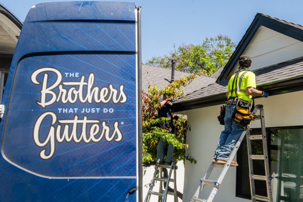 The Brothers That Just Do Gutters van at a residential job